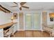Office area with wood-look accent wall, built-in desk/storage, decorative lighting, and glass doors to sitting room at 3215 Cedarbrook Dr, Punta Gorda, FL 33982