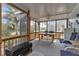 Screened in porch with wood railing, table and chairs, bench, and ceiling fan at 3215 Cedarbrook Dr, Punta Gorda, FL 33982