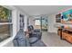 Sun room features lots of natural light, reclining chairs, tile flooring, and a sliding door to backyard at 3215 Cedarbrook Dr, Punta Gorda, FL 33982