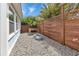 Landscaped side yard with wood fence with climbing vines offers added privacy at 3215 Cedarbrook Dr, Punta Gorda, FL 33982