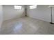 Bright bedroom featuring tile flooring, neutral walls, and natural light from windows at 3420 Dawson Ln, Punta Gorda, FL 33982