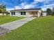Charming one-story home with a well-manicured lawn and long concrete driveway at 3420 Dawson Ln, Punta Gorda, FL 33982