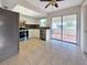 Bright kitchen with modern appliances, white cabinets, and a sliding glass door to patio at 3420 Dawson Ln, Punta Gorda, FL 33982