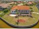 High angle view featuring the backyard, the screened lanai, and the water view of this property at 3705 Toulouse Ct, Punta Gorda, FL 33950