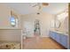 Open bathroom with a soaking tub, double sinks, and an entrance to the main bedroom at 3705 Toulouse Ct, Punta Gorda, FL 33950