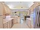Bright kitchen with light wood cabinets and stainless steel appliances, open to living area at 3705 Toulouse Ct, Punta Gorda, FL 33950