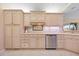 Well-lit kitchen with light-colored cabinetry, stainless steel dishwasher, and tile backsplash at 3705 Toulouse Ct, Punta Gorda, FL 33950