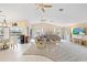 Large living room with vaulted ceiling, ceiling fans, sectional couch, and waterfront view at 3705 Toulouse Ct, Punta Gorda, FL 33950