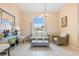 Bright living room with neutral decor, chandelier, and large window overlooking the waterfront at 3705 Toulouse Ct, Punta Gorda, FL 33950