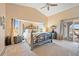 Spacious main bedroom with decorative headboard, vaulted ceiling, and access to outdoor patio at 3705 Toulouse Ct, Punta Gorda, FL 33950