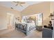 Comfortable main bedroom featuring a decorative metal bed frame, neutral walls, and an attached bathroom at 3705 Toulouse Ct, Punta Gorda, FL 33950