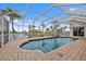 Beautiful waterfront pool with mature landscaping and screened enclosure, great for relaxing outdoors at 3705 Toulouse Ct, Punta Gorda, FL 33950