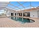 Beautiful screened-in pool with brick patio and seating area, perfect for outdoor entertaining at 3705 Toulouse Ct, Punta Gorda, FL 33950