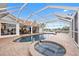 Waterfront pool and spa featuring a large deck and screened-in patio area at 3705 Toulouse Ct, Punta Gorda, FL 33950