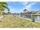 View of backyard with canal access and concrete retaining wall at 3824 Aves Island Ct, Punta Gorda, FL 33950