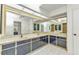 Bright bathroom featuring dual sinks, spacious counter, and large mirror reflecting ample lighting at 3824 Aves Island Ct, Punta Gorda, FL 33950