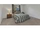 Cozy bedroom with a queen-sized bed, neutral carpet, a ceiling fan, and a window providing natural light at 3824 Aves Island Ct, Punta Gorda, FL 33950