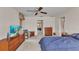 Bright bedroom with plush carpet, ceiling fan, and a view into the bathroom at 3824 Aves Island Ct, Punta Gorda, FL 33950
