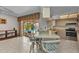 Eat-in kitchen with bar seating, view of pool and patio through sliding doors at 3824 Aves Island Ct, Punta Gorda, FL 33950