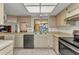 Galley kitchen featuring stainless steel appliances and bright tile at 3824 Aves Island Ct, Punta Gorda, FL 33950