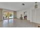Spacious living room with tile flooring, sliding glass doors to the lanai, and pool view at 3824 Aves Island Ct, Punta Gorda, FL 33950