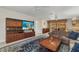 Inviting living room featuring a large TV, built-in shelving, and a view of the pool area through sliding glass doors at 3824 Aves Island Ct, Punta Gorda, FL 33950