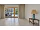 Bright living room with tile flooring and sliding glass doors leading to the lanai and pool at 3824 Aves Island Ct, Punta Gorda, FL 33950