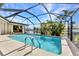Screened in-ground pool with canal view and mature landscaping at 3824 Aves Island Ct, Punta Gorda, FL 33950