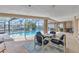 Enclosed pool area with a patio set for entertaining, waterfront views, and lush landscaping at 3824 Aves Island Ct, Punta Gorda, FL 33950