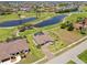Aerial view of home with a screened lanai, pool, and golf course views at 4001 La Costa Island Ct, Punta Gorda, FL 33950