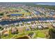 An aerial view shows the community's waterfront homes, golf course, and waterways at 4001 La Costa Island Ct, Punta Gorda, FL 33950