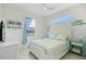 Bright bedroom with a white bed frame, turquoise accents, and a view of the outdoor pool at 4001 La Costa Island Ct, Punta Gorda, FL 33950