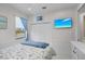 Inviting bedroom featuring a patterned bedspread, a TV mounted on the wall, and a closet at 4001 La Costa Island Ct, Punta Gorda, FL 33950
