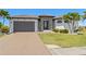 Charming single-Gathering home features a tile roof, an attached garage, and a well-manicured lawn at 4001 La Costa Island Ct, Punta Gorda, FL 33950