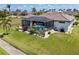 An exterior view highlights the screened-in pool and manicured lawn of this home at 4001 La Costa Island Ct, Punta Gorda, FL 33950