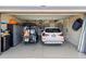 Well-organized garage with a golf cart, a parked car, and ample storage space for tools and equipment at 4001 La Costa Island Ct, Punta Gorda, FL 33950