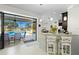 Modern kitchen with breakfast bar that opens onto screened outdoor pool and lanai at 4001 La Costa Island Ct, Punta Gorda, FL 33950