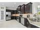 Gourmet kitchen features stainless steel appliances, dark wood cabinetry, and granite countertops at 4001 La Costa Island Ct, Punta Gorda, FL 33950
