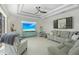 Bright, neutral living room with tray ceilings, recessed lighting, and lots of comfortable seating at 4001 La Costa Island Ct, Punta Gorda, FL 33950