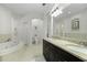 Main bathroom with double sinks, a soaking tub, and lots of counter space at 4001 La Costa Island Ct, Punta Gorda, FL 33950