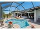Step into luxury with this screened-in pool, perfect for relaxation and entertainment at 4001 La Costa Island Ct, Punta Gorda, FL 33950