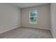 This bedroom features neutral walls, carpet flooring, and a window that brings in natural light at 4127 Snowdrop St, North Port, FL 34288