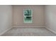 Cozy bedroom featuring neutral carpet, trim, and a window at 4127 Snowdrop St, North Port, FL 34288