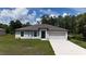 Charming single-story home with a well-maintained lawn and attached two-car garage at 4127 Snowdrop St, North Port, FL 34288