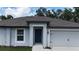 Close-up of a home's front entrance, complete with a gray door and attached garage at 4127 Snowdrop St, North Port, FL 34288