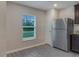 Bright kitchen area featuring stainless steel refrigerator, neutral paint, and wood look floors at 4127 Snowdrop St, North Port, FL 34288