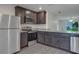 Modern kitchen with stainless steel appliances, granite counters, and ample cabinet space at 4127 Snowdrop St, North Port, FL 34288
