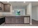 Modern kitchen features gray cabinets, granite countertops, and stainless steel appliances at 4127 Snowdrop St, North Port, FL 34288