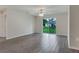 Bright living room features sliding glass door leading to backyard and wood look floors at 4127 Snowdrop St, North Port, FL 34288