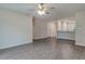 Open living room with wood-look floors, neutral paint, and ceiling fan at 4127 Snowdrop St, North Port, FL 34288